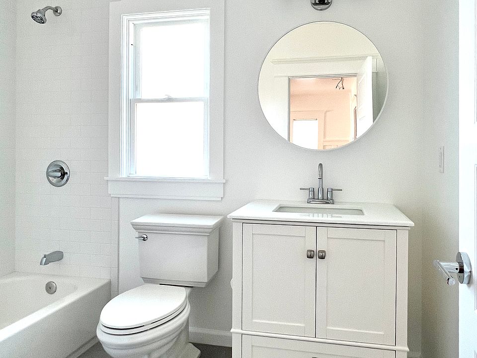 Beautiful bathroom with new high-end fixtures and finishes! Round mirror over sink opens and has multiple shelves.