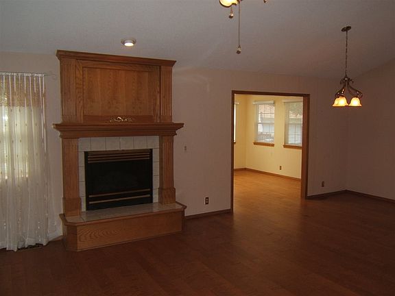Gas fireplace in living room with adjoining dinning area.