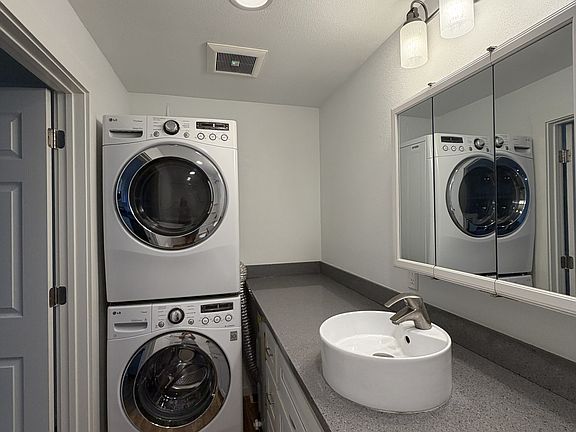 Bathroom with stackable full washer and dryer