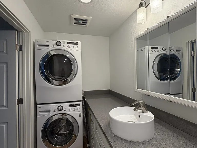 Bathroom with stackable full washer and dryer