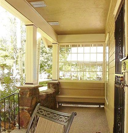 Covered front porch with new indoor/outdoor carpeting and built-in benches on bo