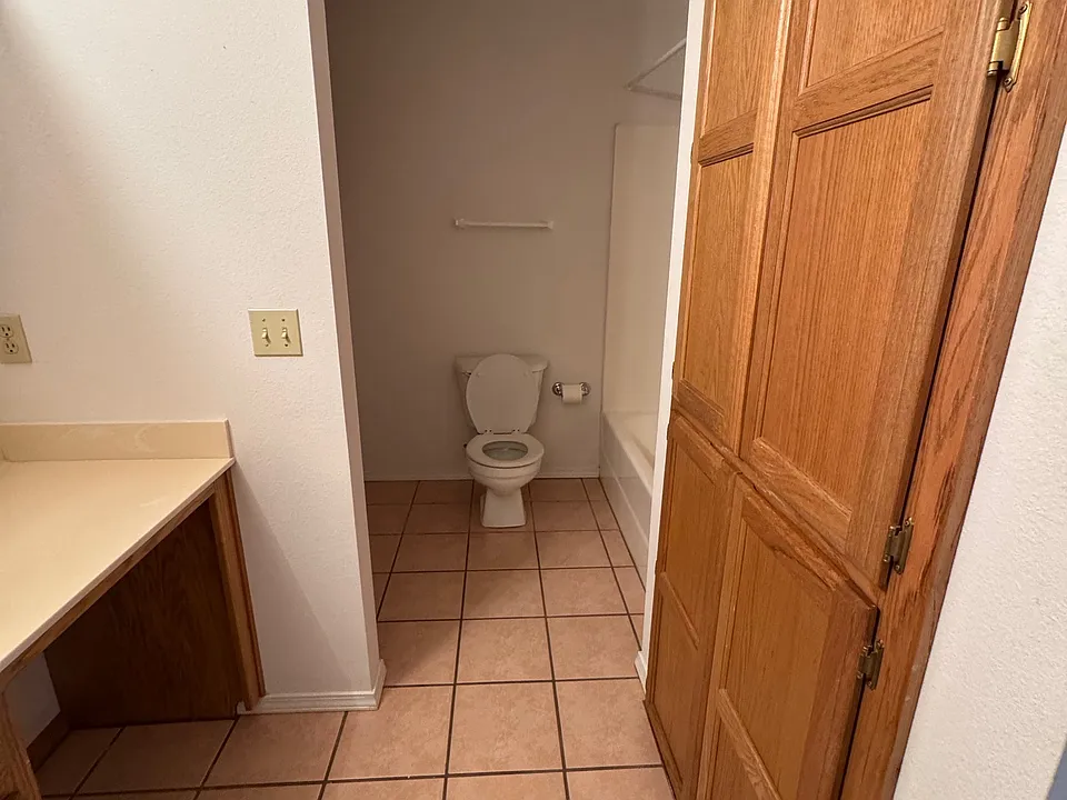 Washer and dryer hookup beside the toilet on the opposite side of the tub. Plenty of storage