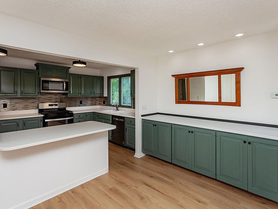 Sage green kitchen with shiplap walls in a Toronto home, Ontario