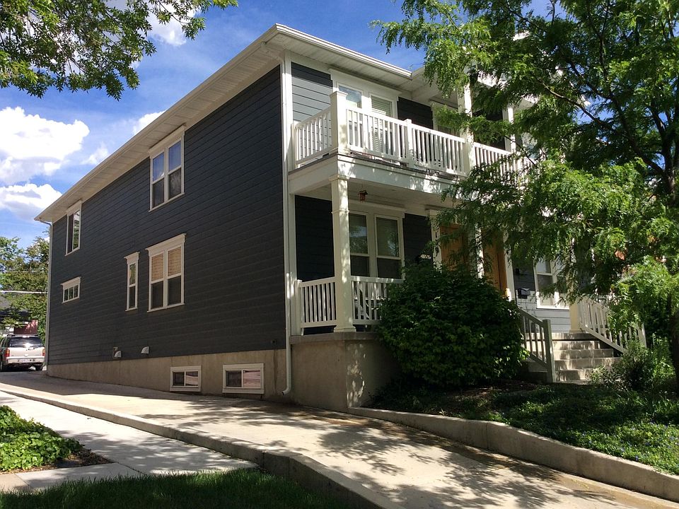 Front side of the house with driveway leading to the back of the unit where there is reserved parking and a one car garage