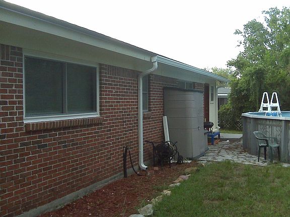 Back of house with pool at back door