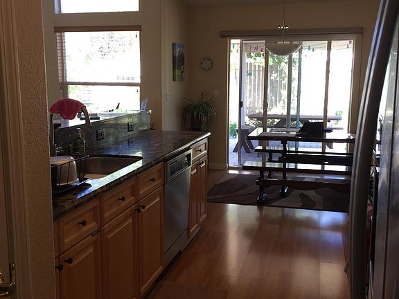 Kitchen and breakfast nook facing covered backyard