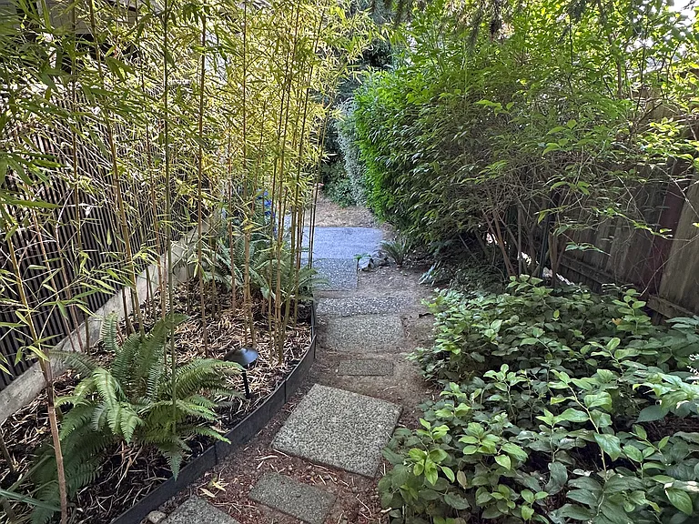 Private tenant entrance with pathway leading to the front door.
