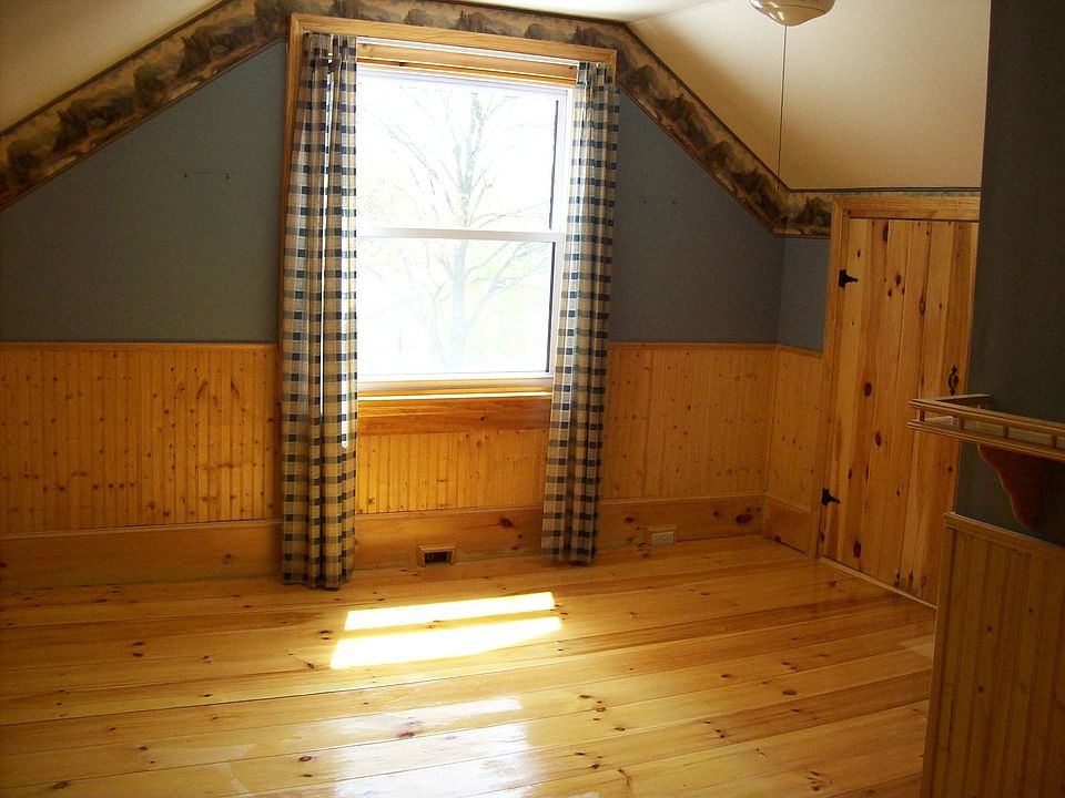 master bedroom with pine wood floors