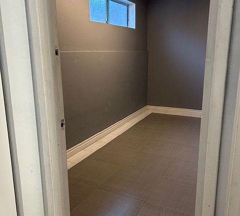 a small bedroom or storage room next to garage at bottom level