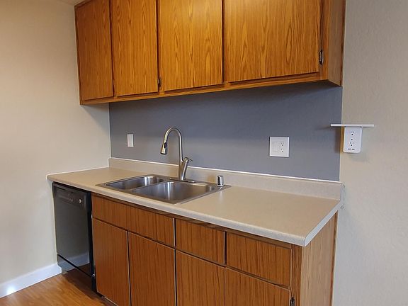 Newly remodeled kitchen with dishwasher, electric range, overhead microwave and wall USB port shelf