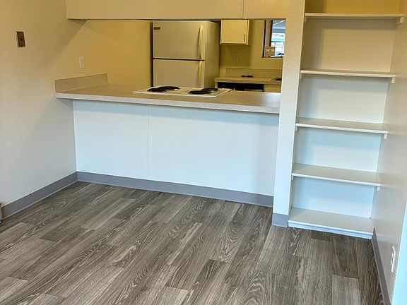 Dining room with additional storage shelves.