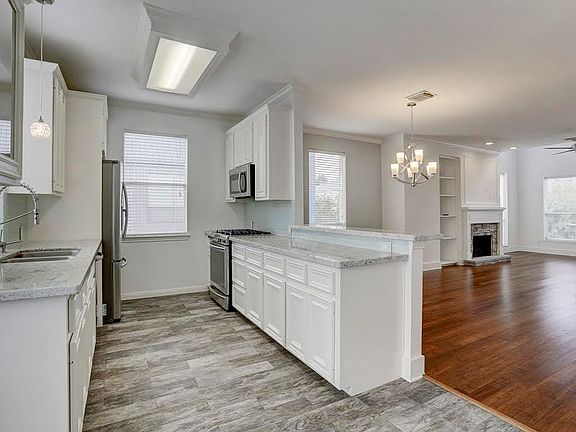 The kitchen has been updated with a stainless steel appliance package .