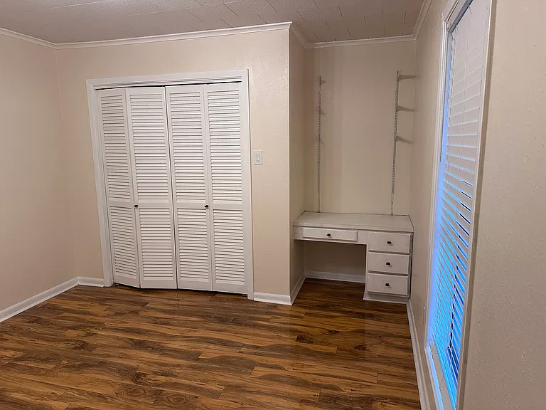 3rd bedroom with desk and closet