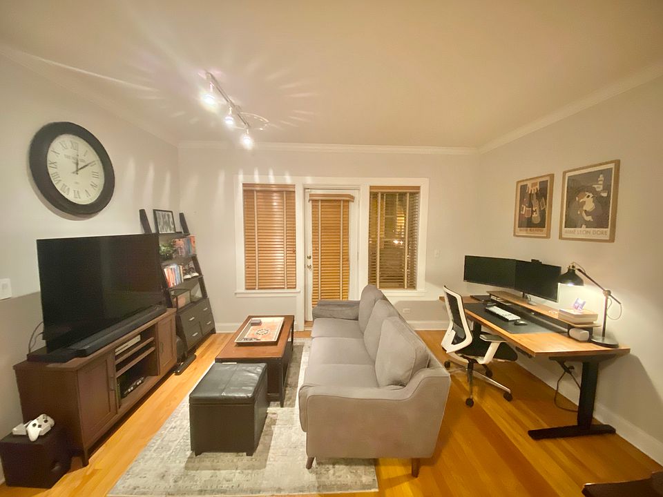 The living room leads to the balcony and is open to the kitchen.