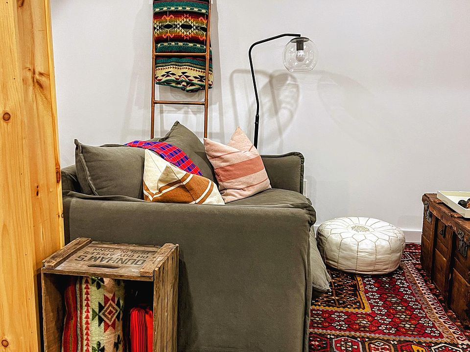 A comfortable lounging area is decorated with carpets, pillows and blankets from around the world.