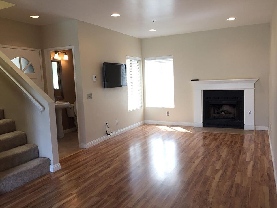 Living room with joint powder room; mounted flat screen TV i