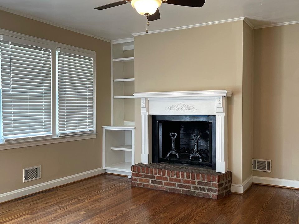 Great Room with custom built shelving by Fireplace (New Blinds Installed in every window throughout house.