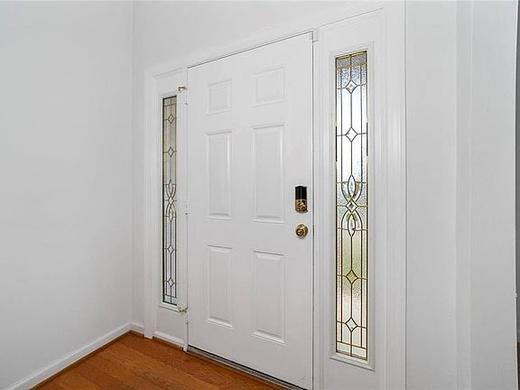 Beautiful entrance door. Hardwood floor at entry.Security system.