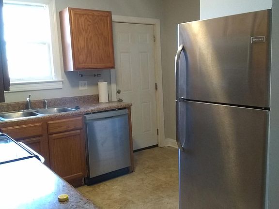Cozy kitchen with a dishwasher and refrigerator.