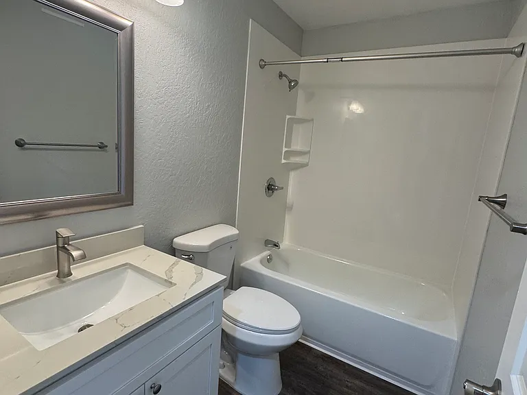 Upstairs full bathroom has been remodeled with new flooring, sink and vanity, new tub/shower enclosure and new lighting.