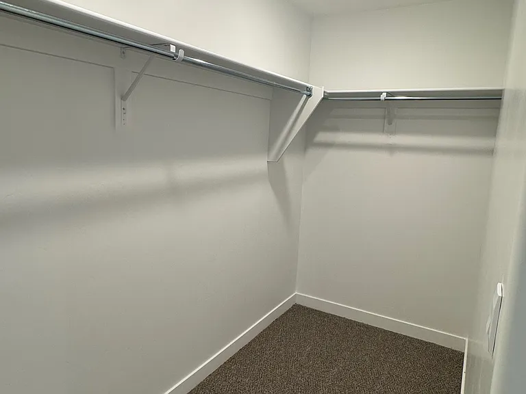 Primary bedroom walk-in closet