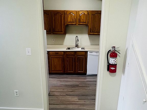 hallway with storage and new flooring.
