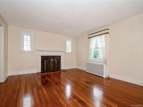 Living Room on the 2nd floor for the unit occupying the 2nd and 3rd Floors. Please note the fireplace and hardwood floors.