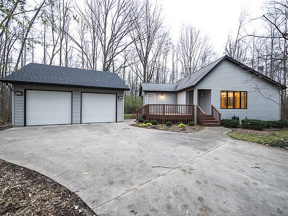 Although the house has a Midland mailing address, it is located in Williams Township and the Auburn Elementary and Bay City Western school district.  The house was built in 1985 and has been impeccably maintained since that time.  The wooded lot measures approximately 337 feet by 255 feet, two full acres, and backs up to a field.  The cedar deck shown here leads to both the front door and the side entrance.