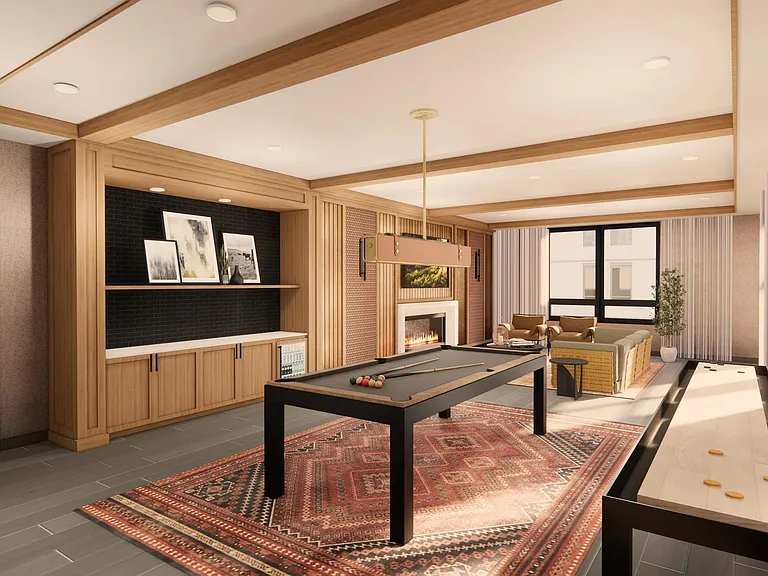 Gather in the game room at Modera Bridle Trails, where warm wood tones, a fireplace, and games create a space to unwind together.