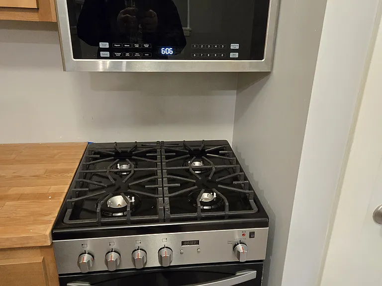 Kitchen with new ss appliances with hood microwave