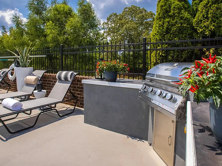 Immerse yourself in the art of outdoor cooking at our poolside kitchen, complete with a stainless-steel gas grill and inviting seating by the resort-style poolan enchanting al fresco culinary adventure.