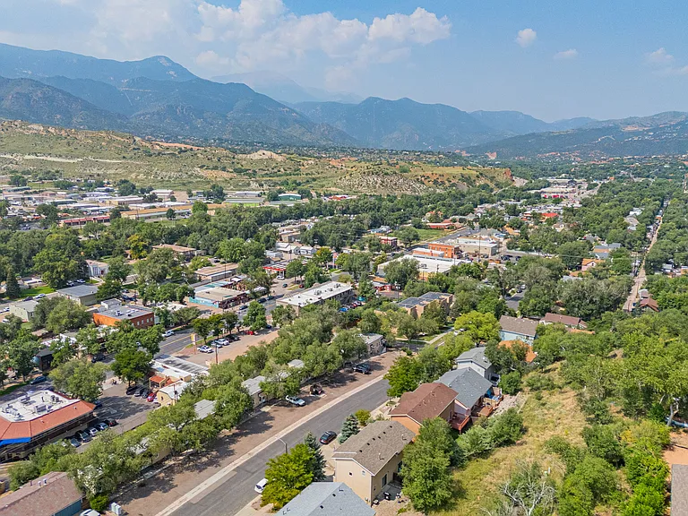 Aerial view of house nestled amongst trees in vibrant Old Colorado City neighborhood