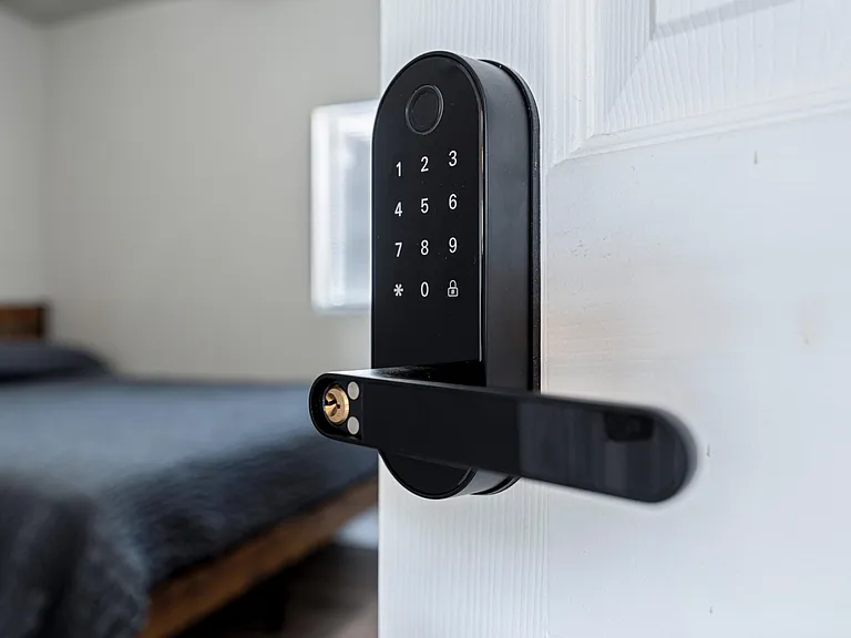 Bedroom entry features a keypad lock for convenient keyless access and added peace of mind for residents.