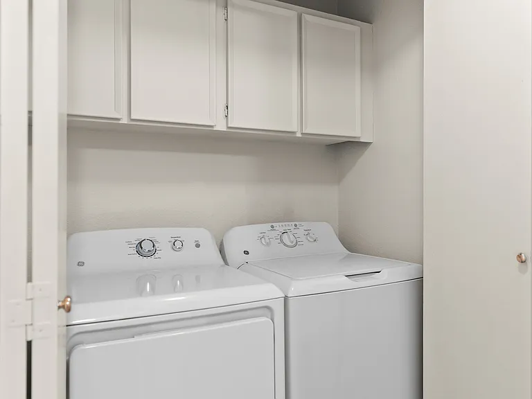Convenient in-home laundry with storage space.