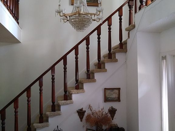 Two-story foyer, walnut staircase