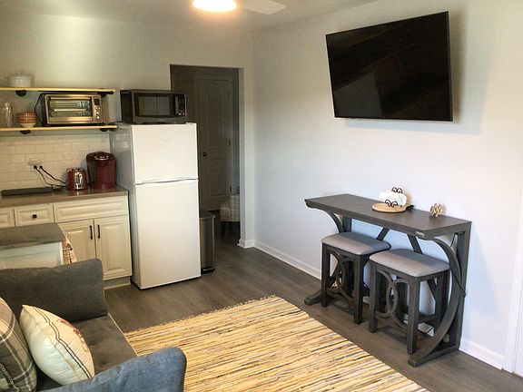 Fully equipped mini kitchen with appliances and 3/4 freezer fridge. Seating for 2 at dining table.