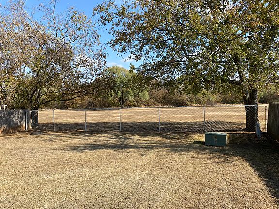 Your view from the back yard. It's like being in the country. The newly installed chain link fence allows for a great view and provides a five foot security barrier.