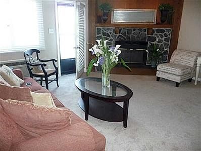 Living Room. Original stone fireplace was left for that lake lodge feel and this is a wood-burning fireplace with lights above you can dim for those cozy nights