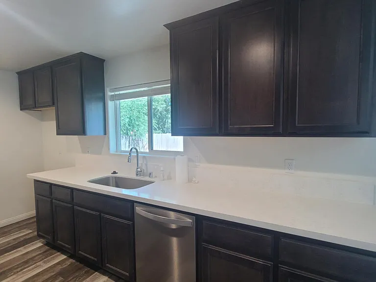 Kitchen. Window to the backyard. Ample counter space and cabinet storage.