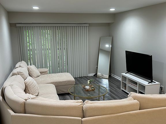 living with luxury vinyl plank floors, recessed lights and sliding doors to nice balcony,