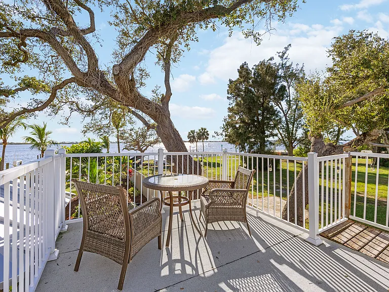 OWNERS SUITE UPPER DECK OFF MASTER BEDROOM OVERLOOKING GARDENS AND BAY