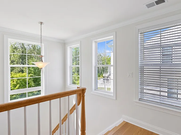 Beautiful windows guide you upstairs to the bedrooms, laundry area, hall bathroom and linen closet.
