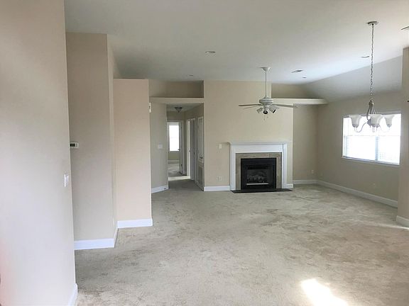 Living/dining area and hallway to bedrooms 2 and 3; gas logs