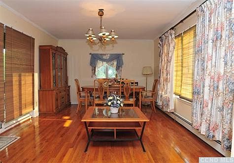 Diningroom has new hardwood floors, large windows to enjoy the Catskill Mountain views and sliding doors to screened porch.