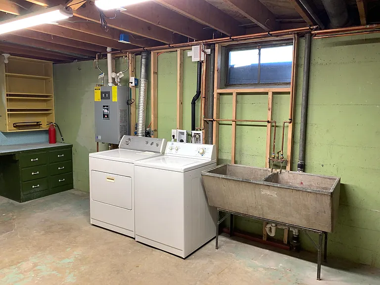 Utility room, washer, dryer, utility sink, and tankless water heater