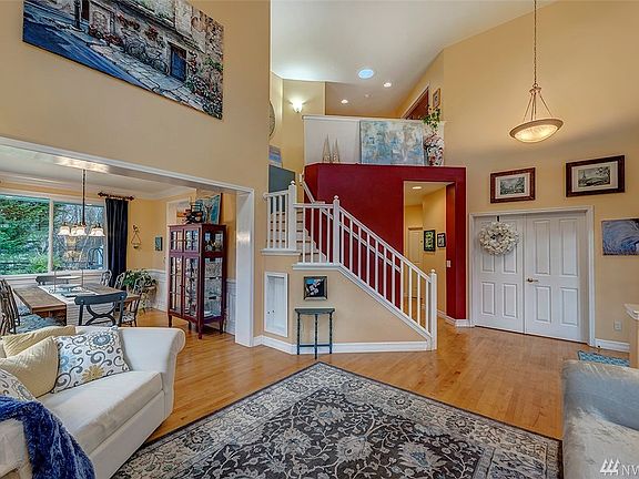 View from living room to dining room, den and back towards kitchen and family room.