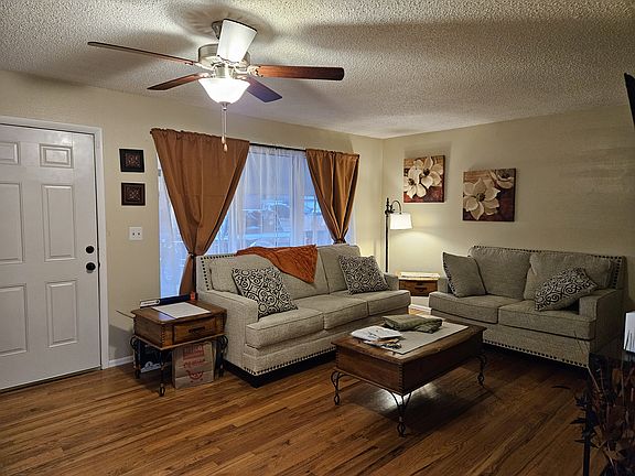 Spacious living room with large window for natural lighting. New furniture, couch and love seat
