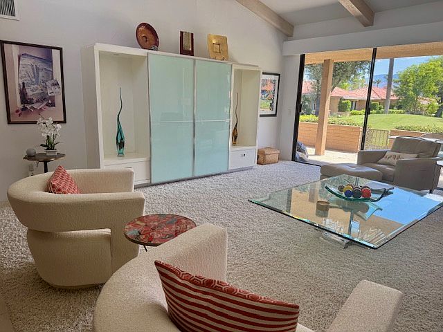 Living area looking out to back patio and golf course.