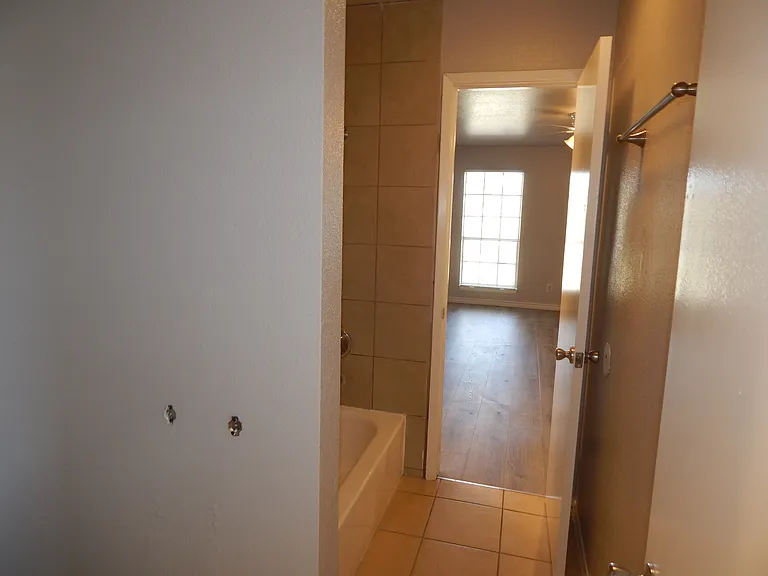 2 bed townhome, bath with view to master bed