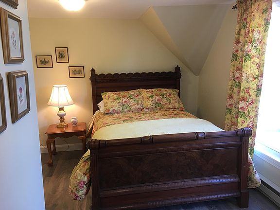 The bedroom features a gorgeous antique double bed, good closet space and a lovely dresser.